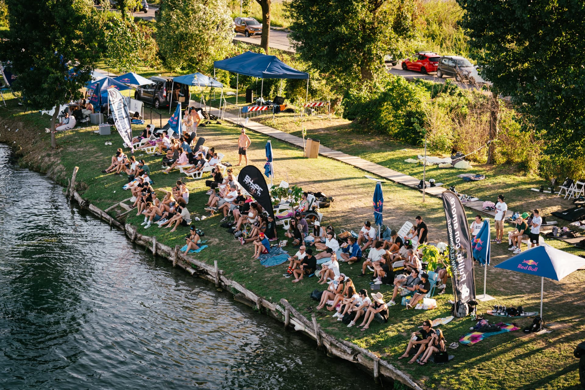 Riders and fans gathered on the lakeside lawn watching a cable wake event